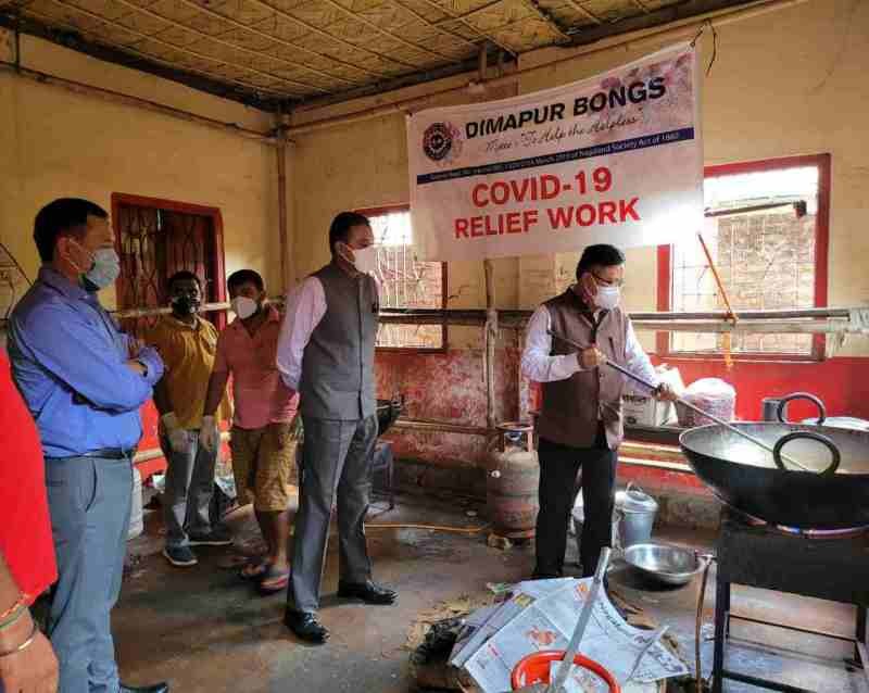 State nodal officer for Dimapur district to manage COVID-19 activities, Y Kikheto Sema, extends a helping hand at a COVID kitchen managed by Dimapur Bongs during his visit along with district officials on June 9 in Dimapur.